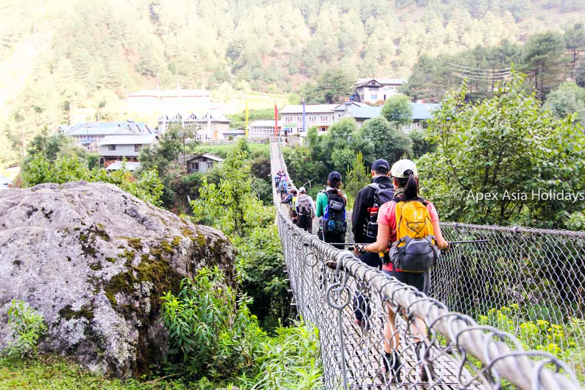 Trekkers And Trekking Crew Are Crossing A Supension Bridge Along The Everest Base Camp Trekking Route